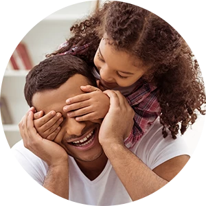 A daughter plays with her father, putting her hands over her eyes